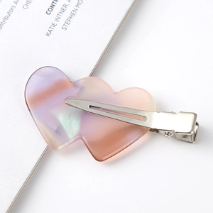 Macro view of double heart hair clip with purple and orange gradient resin finish