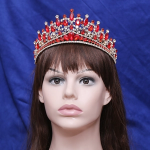 Golden baroque bridal crown with elegant red rhinestones and crystals on model