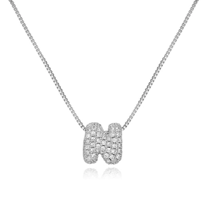 Macro shot of silver box chain necklace with iced out cubic zirconia letter N pendant