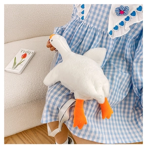 Detailed view of white goose plush crossbody bag with gray adjustable strap and orange beak