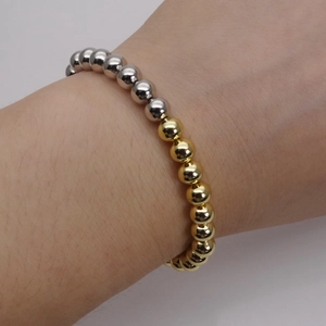 Adjustable two-tone gold and silver beaded bracelet with polished metallic round beads