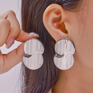 Minimalist silver teardrop earrings with a geometric curved design in polished finish