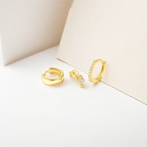 Detail of 3-piece gold S925 silver earring set with lightning stud and polished huggie hoops
