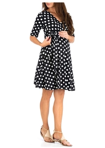 Detailed view of white polka dot pattern on black maternity dress with V-neck and waist tie