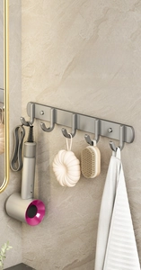 Detailed view of matte silver five-hook rack installed on marble wall for bathroom storage