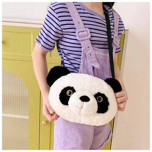Detail of cute panda plush bag with black shoulder strap worn by a model in soft lighting