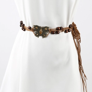 Detail of woven brown waist chain with a metallic butterfly buckle and amber gems