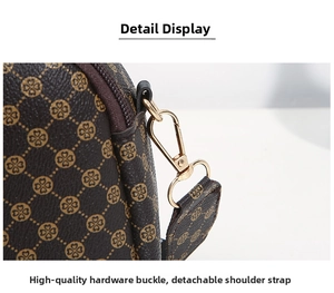 Detail of premium gold hardware buckle and detachable strap on vintage printed handbag