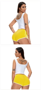 Side and back view of white sports tank top and yellow elastic yoga shorts set for women