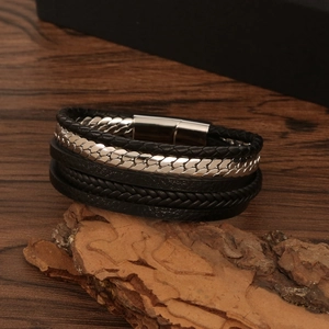 Macro detail of multi-layer leather braid and polished steel magnetic clasp on bark