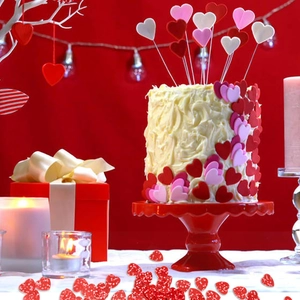 Detail of red heart sequins and festive cake toppers for Valentine's Day party decor