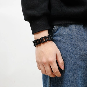 Detailed view of matte black stainless steel motorcycle chain bracelet on wrist
