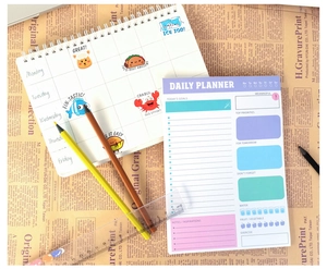 Detailed view of daily planner and weekly tracker with cartoon goals and priorities sections