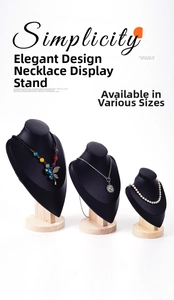 Three-piece black velvet necklace display stands with round wooden bases in varying heights