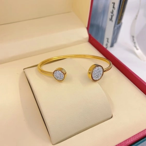 Gold open bangle bracelet with cubic zirconia set in a red velvet jewelry gift box