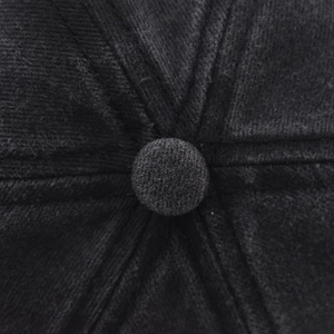 Macro shot of high-quality stitching and top button on a washed vintage baseball cap