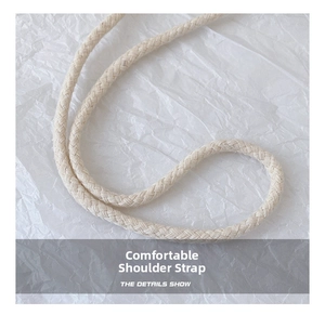 Macro shot of durable off-white woven shoulder strap detail for children straw bag