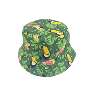Detail of green bucket hat with tropical toucan and monstera leaf print patterns