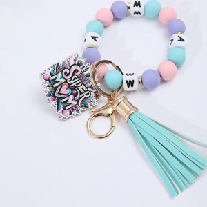 Detail of silicone bead keychain with leather tassel and Super Mom floral pendant