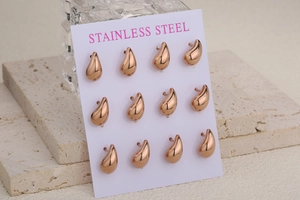 Macro view of 12 rose gold teardrop stud earrings displayed on a card holder