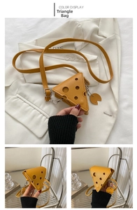 Detail of yellow triangle cheese-shaped PU mini bag with decorative holes and strap