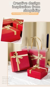Detail of red festive gift boxes with gold bows and matching frosted tote bags