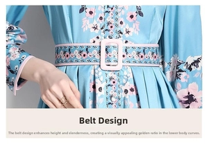 Detail of waist design with floral belt and pink rectangular buckle on blue dress