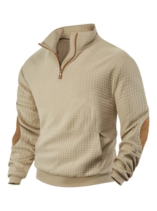 Detail of khaki waffle-knit pullover with brown suede elbow patches and ribbed cuffs
