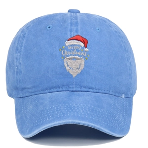 Detailed close-up of Santa Claus embroidery on light blue washed cotton baseball cap