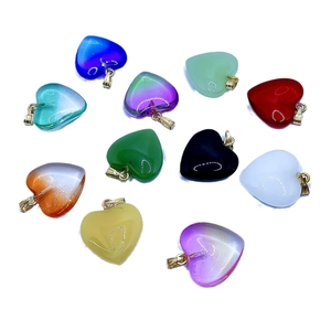 Colorful heart-shaped glass pendants with gold bails shown in eleven vibrant color options