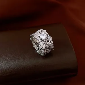 Elegant silver openwork ring with large center cubic zirconia and geometric cutout patterns