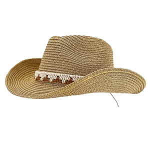 Golden straw cowboy sun hat with wide brim and ethnic woven band for summer travel