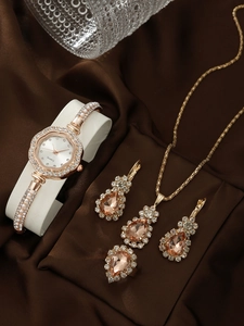 Detail view of rose gold quartz watch set with rhinestones and gems on brown silk