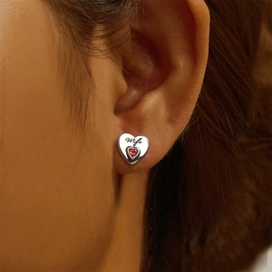 Close-up of 925 sterling silver heart stud earring with red zircon and Wife engraving