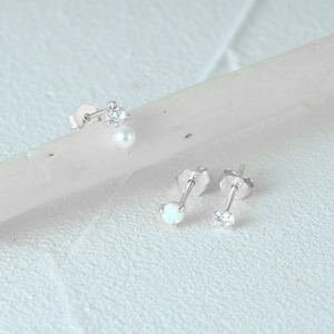 Detail view of 925 sterling silver butterfly, pearl, and opal studs with S925 hallmark