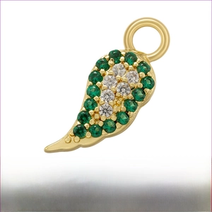 Macro detail of gold-plated wing pendant with green and white micro-pave zircons
