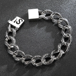 Retro punk style thick silver chain bracelet with intricate floral carvings and S clasp