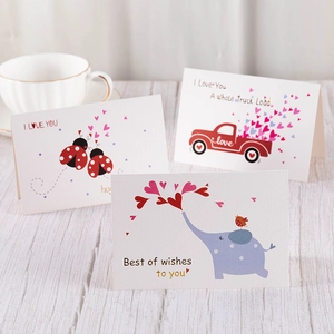 Three elegant greeting cards with gold stamping hearts on a white wooden background