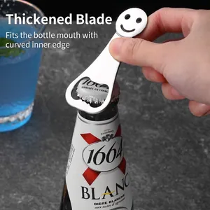 Flat stainless steel beer bottle opener with smiley face design used on a cold bottle