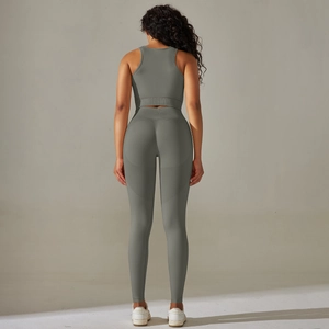 Seamless peach lift yoga set featuring racerback crop top and high-waisted leggings in grey-green