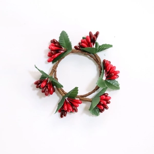 Christmas red berry napkin ring with artificial berries and green leaves on brown vine base
