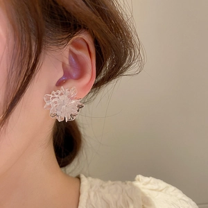 Close-up of translucent resin flower stud earring with ice-crack texture on ear