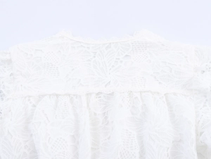 Close-up of white floral lace texture and intricate hollow-out embroidery detail