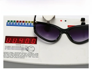 UV400 test demonstration of butterfly sunglasses with black frames and purple gradient lenses