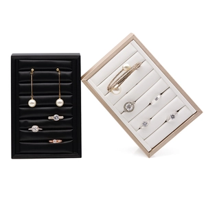 Minimalist jewelry display tray in black and champagne gold for rings and earrings
