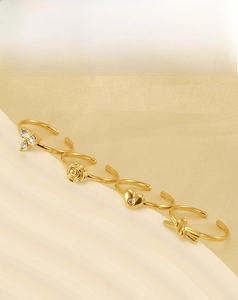 Detail of four 18k gold plated stainless steel rings with adjustable open bands