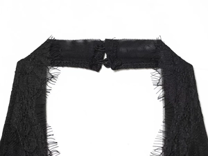 Close-up of black lace halter neckline with mesh detail and metal clasp fastening