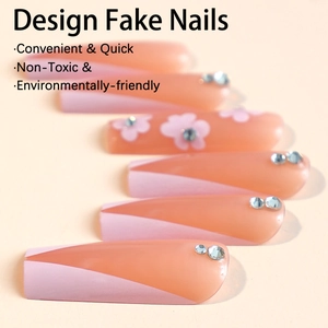 Long coffin false nails featuring pink floral patterns and rhinestones on nude base