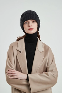 Detailed view of black ribbed knit beanie showing soft texture and cozy winter fit