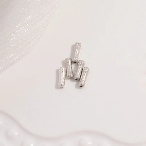 Macro shot of silver irregular hammered bamboo tube spacer beads for jewelry making